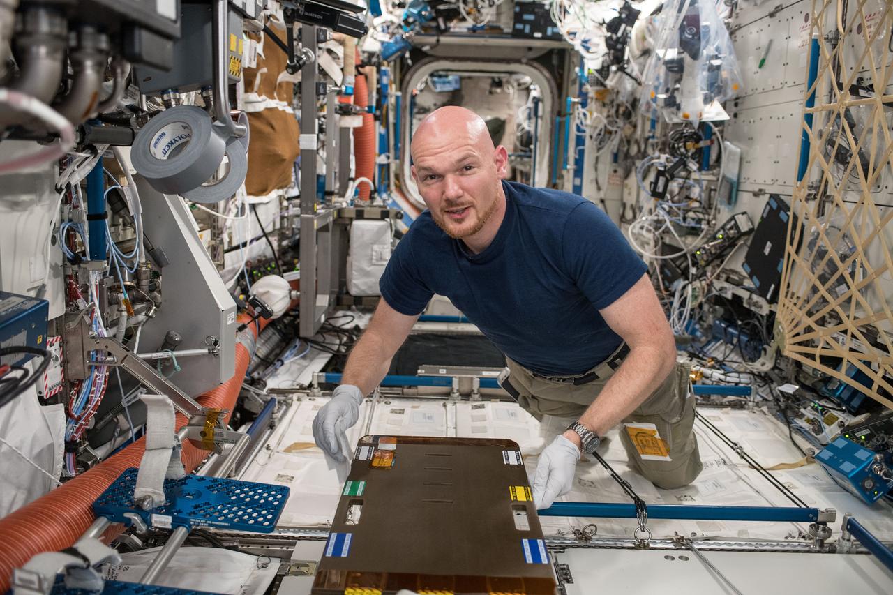 iss056e130414 (July 28, 2018) --- Astronaut Alexander Gerst of ESA (European Space Agency) cleans the Crew Medical Restraint System (CMRS) inside the International Space Station's U.S. Destiny Laboratory. In the event of a medical emergency aboard the station a crew member would be secured in the CMRS.