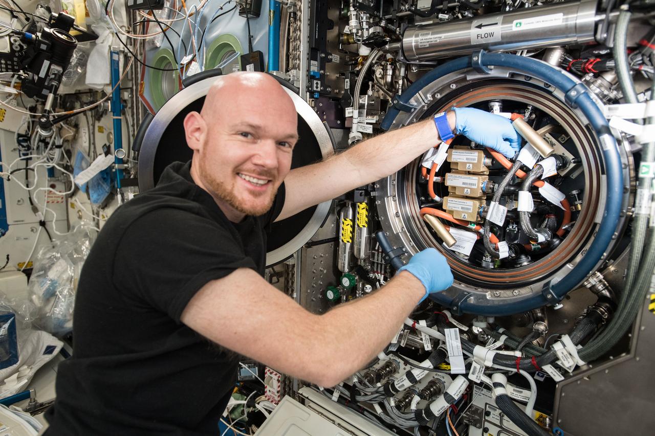 iss056e130647 (Aug. 10, 2018) --- Astronaut Alexander Gerst of ESA (European Space Agency) works inside the Combustion Integrated Rack replacing gear for a set of five independent studies of gaseous flames called ACME, or Advanced Combustion via Microgravity Experiments.