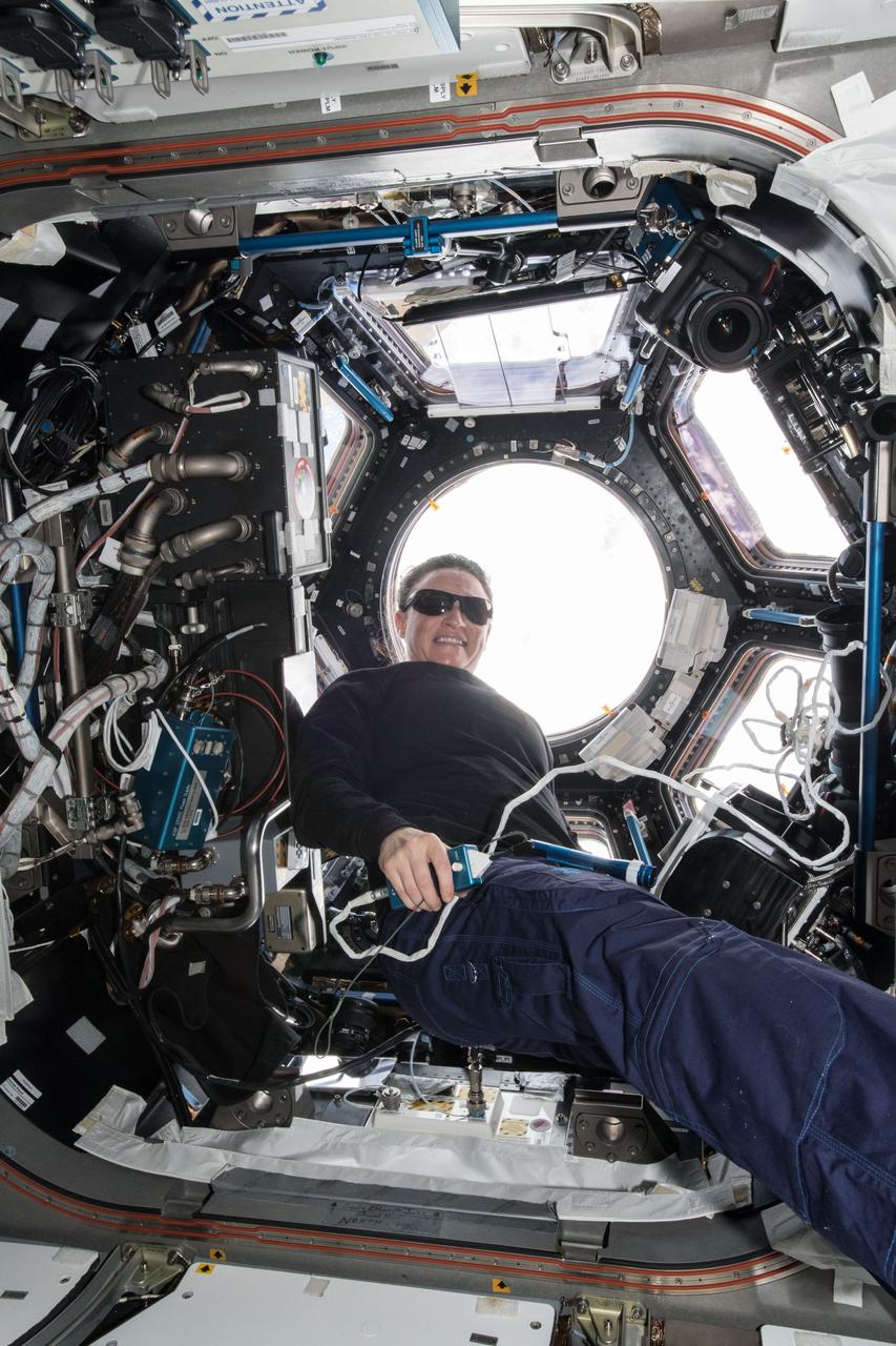 iss056e152943 (Aug. 23, 2013) --- NASA astronaut Serena Auñon-Chancellor wears sunglasses in the brightly-lit Cupola, the International Space Station's "window to the world," as the orbital complex orbits above the Atlantic Ocean off the coast of France nearly 253 miles below.