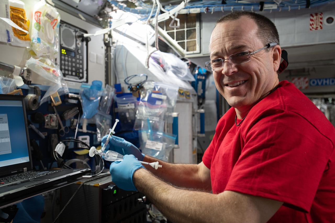iss056e158445 (Aug. 27, 2018) --- NASA astronaut Ricky Arnold is pictured working inside NASA's U.S. Destiny laboratory module on an experiment that extracts RNA from biological samples to help researchers decipher the changes in gene expression that take place in microgravity.