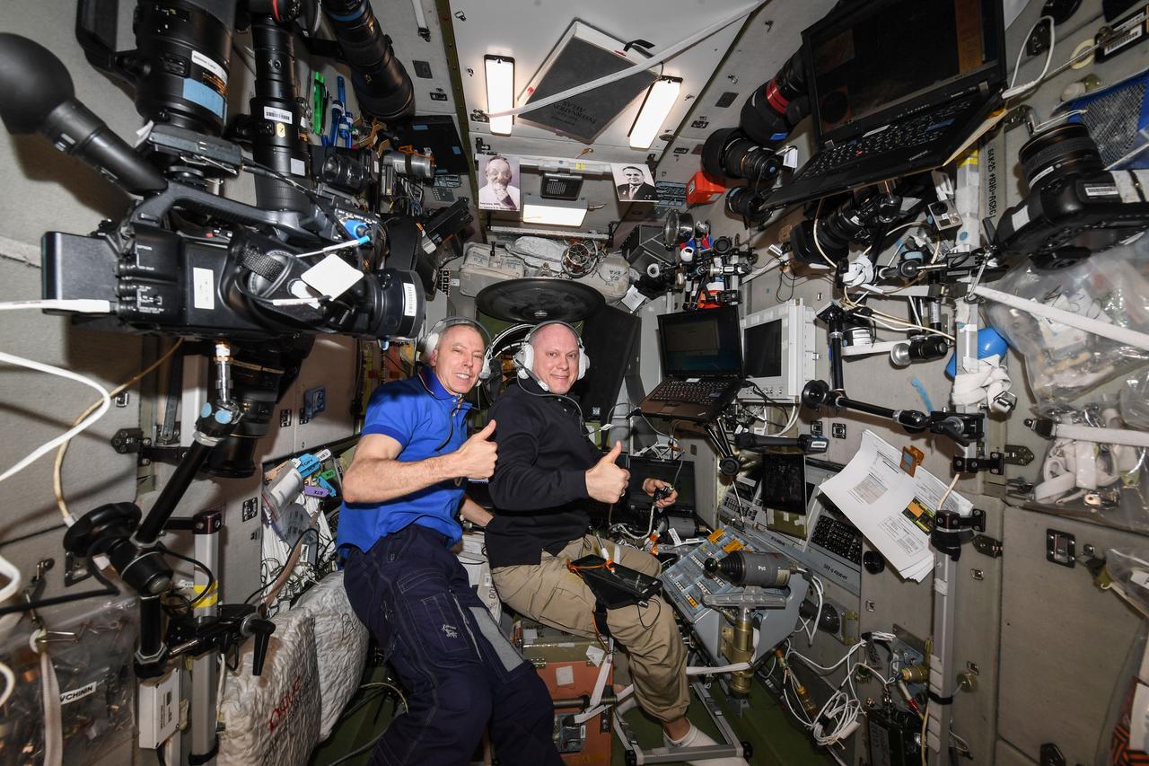 iss056e186451 (Sept. 24, 2018) --- (From left) Expedition 56 Commander Drew Feustel of NASA and Soyuz MS-08 Commander Oleg Artemyev of Roscosmos practice on a computer the Soyuz descent procedures they will use when they return to Earth on Oct. 4. NASA astronaut Ricky Arnold (out of frame) will join the duo for the ride home inside the Soyuz MS-08 spacecraft ending the Expedition 56 mission.