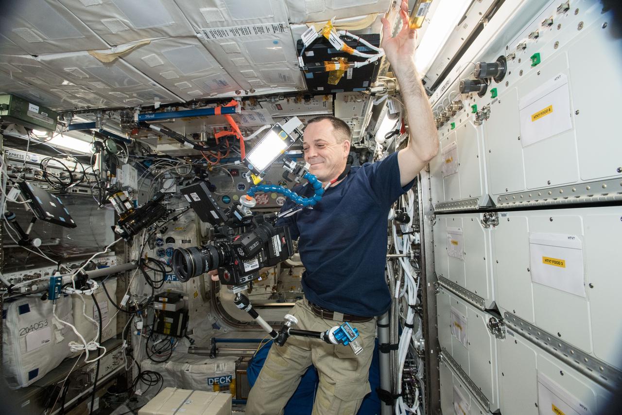 iss056e200804 (10/3/2018) --- NASA astronaut Ricky Arnold using the RED Helium Camera. The RED HELIUM 8K camera is a high-resolution cinema camera capable of 8K resolution.