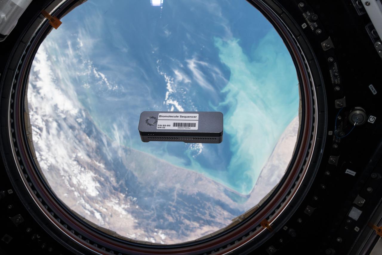 iss057e000180 (10/8/2018) - Biomolecule Sequencer for the BEST experiment floating in front of Window 7 in the Cupola module. Earth is in the background. The Biomolecule Sequencer seeks to demonstrate, for the first time, that DNA sequencing is feasible in an orbiting spacecraft. A space-based DNA sequencer could identify microbes, diagnose diseases and understand crew member health, and potentially help detect DNA-based life elsewhere in the solar system.