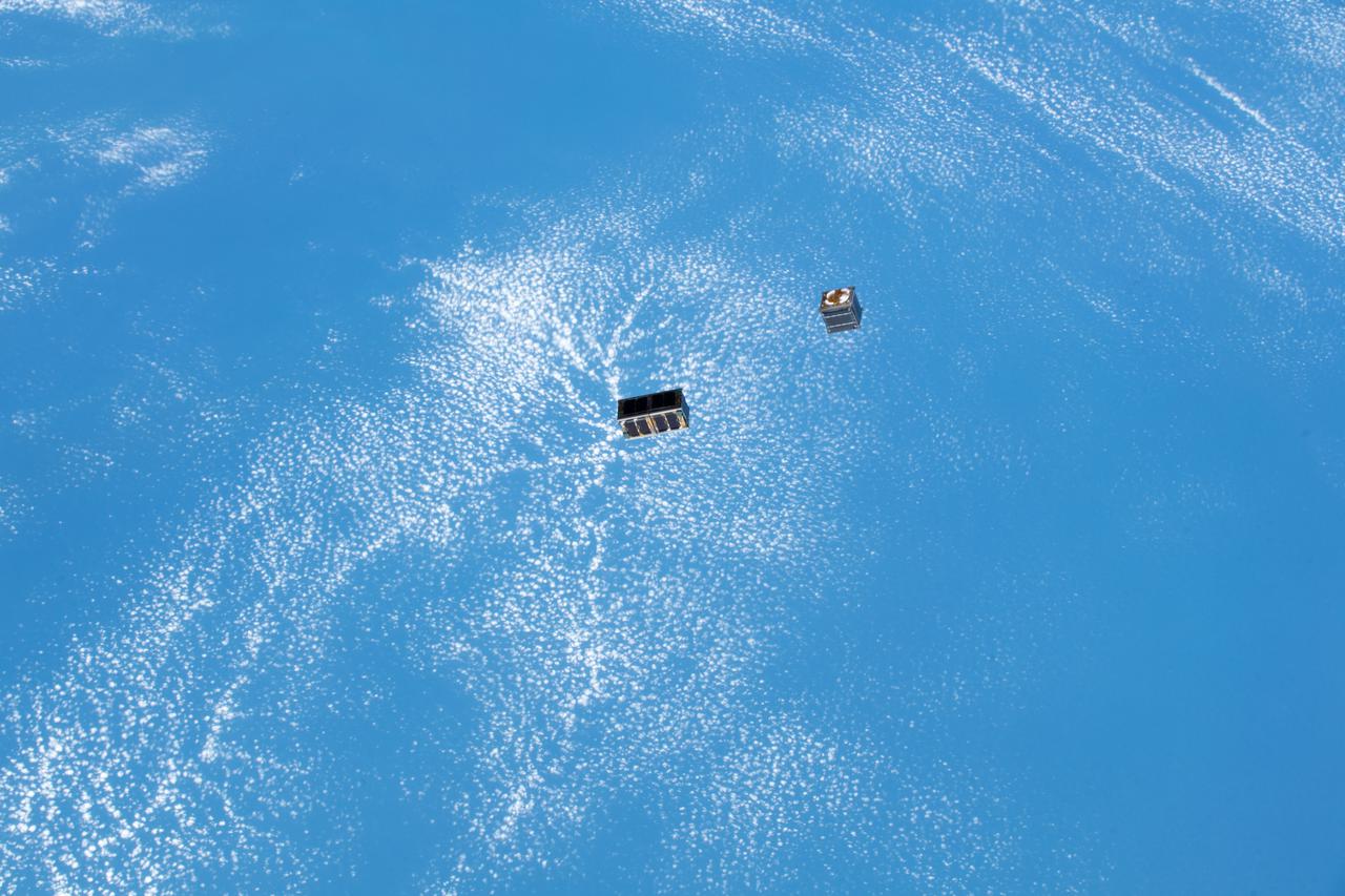 iss057e006099 (10/6/2018) --- Documentation of two deployed Japan Aerospace Exploration Agency (JAXA) CubeSats, STARS-Me and RSP-00, during the JEM [Japanese Experiment Module]-Small Satellite Orbital Deployer 10 (J-SSOD 10) mission. Earth is in the background.