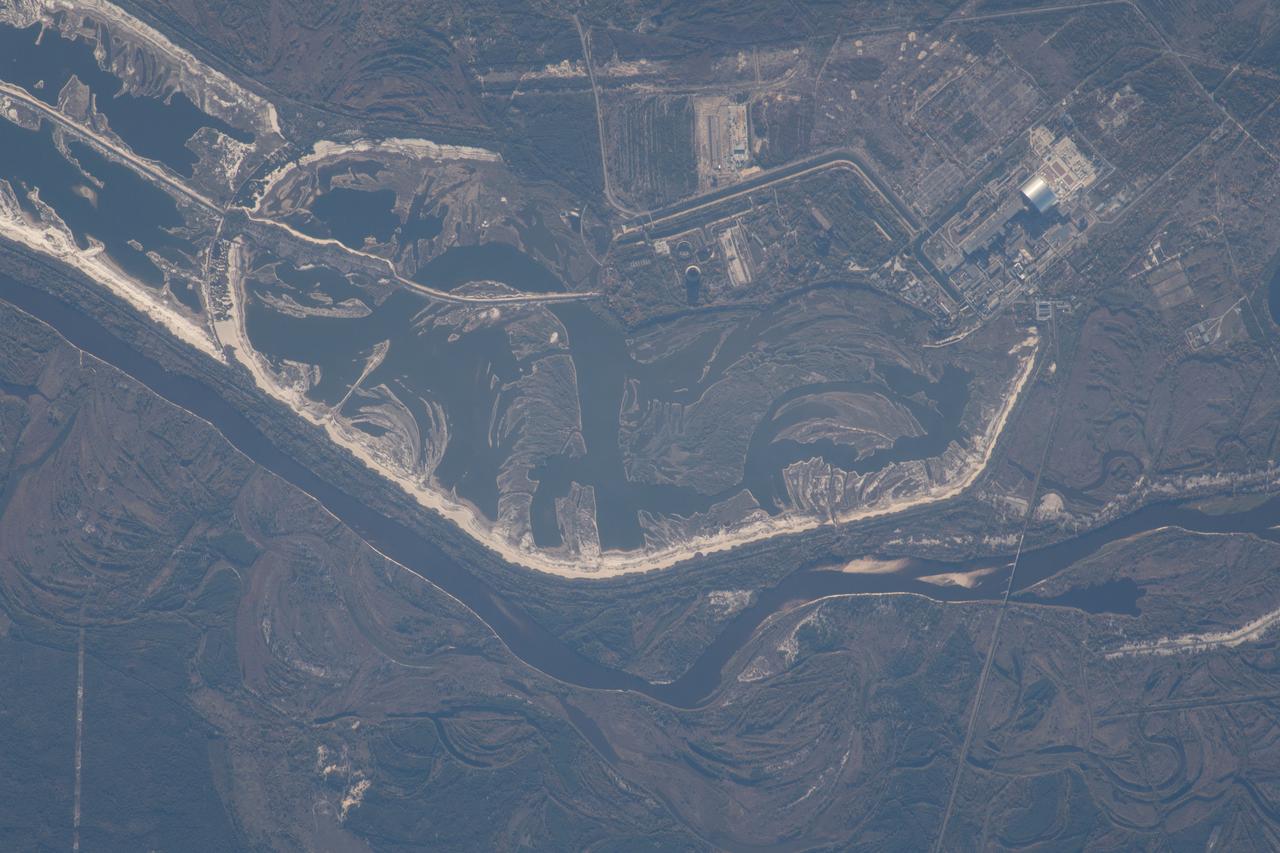 iss057e051419 (Oct. 14, 2018) --- The Chernobyl Nuclear Power Plant on the Pripyat River in northern Ukraine was pictured as the International Space Station orbited 257 miles above Eastern Europe. Across the Ukrainian border in Belarus, the Polesie State Radioecological Reserve was created to enclose territory most affected by radioactive fallout from the Chernobyl disaster.