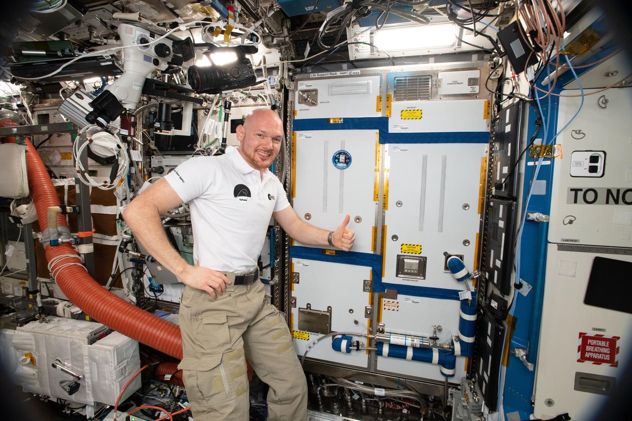 iss057e055227 (Oct. 19, 2018) --- Expedition 57 Commander Alexander Gerst of ESA (European Space Agency), surrounded by exercise and science gear inside the U.S. Destiny laboratory, gives a thumbs up sign after completing maintenance work on a Life Support Rack.