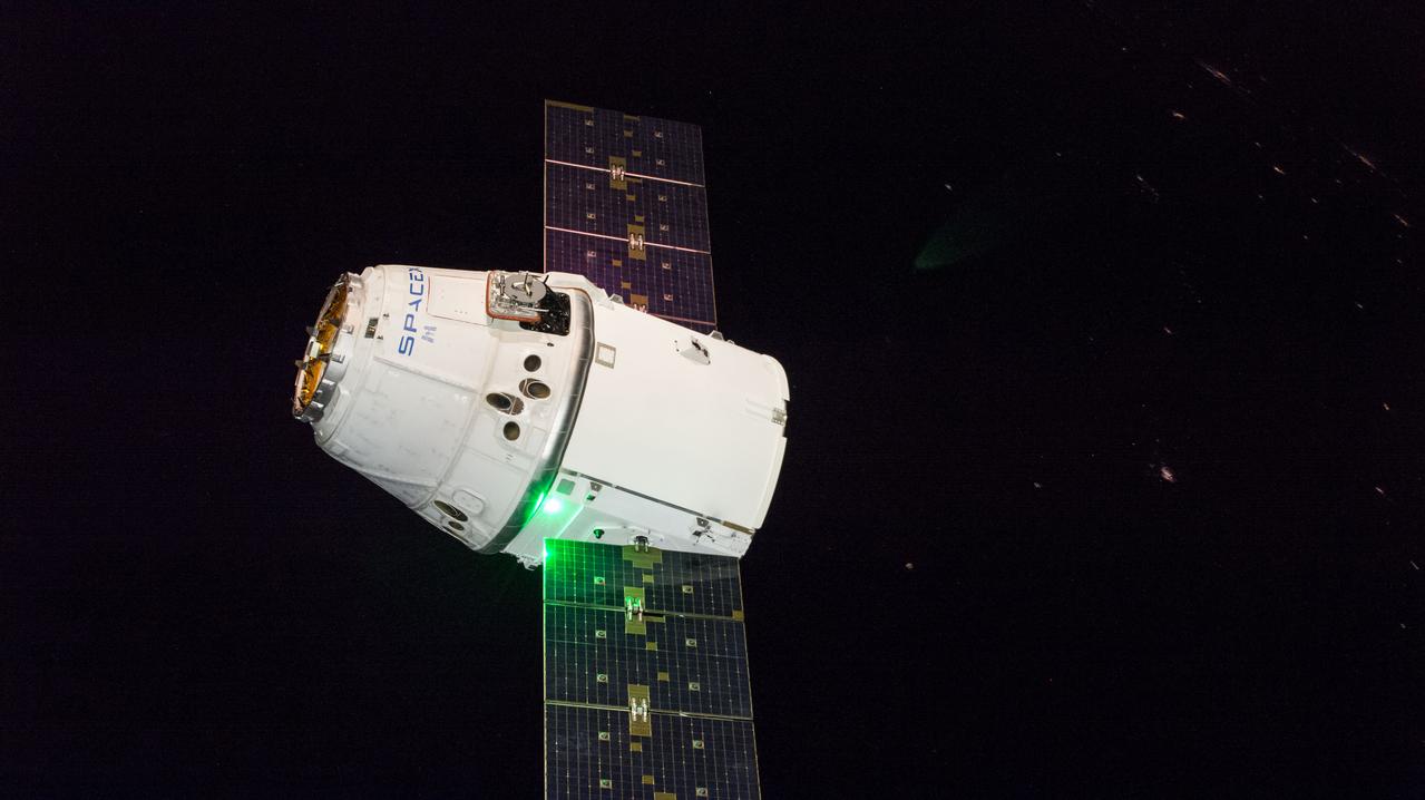iss057e115431 (Dec. 8, 2018) --- The SpaceX Dragon cargo craft slowly approaches the International Space Station. Astronauts Alexander Gerst and Serena Auñón-Chancellor were monitoring Dragon from inside the cupola and preparing to slowly reach out and grapple the cargo craft with the Canadarm2 robotic arm. Dragon, packed with over 5,600 pounds of cargo, completed a three-day trip to the International Space Station that began with a launch from Cape Canaveral Air Force Station in Florida and ended with its installation and hatch opening on the Harmony module..