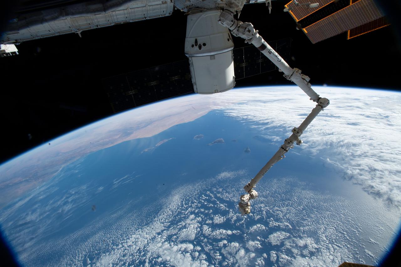 iss058e000081 (Dec. 22, 2018) --- The SpaceX Dragon cargo craft and the Canadarm2 robotic arm are pictured attached to the International Space Station as the orbital complex was 251 miles above the Atlantic Ocean about to fly over Morocco.
