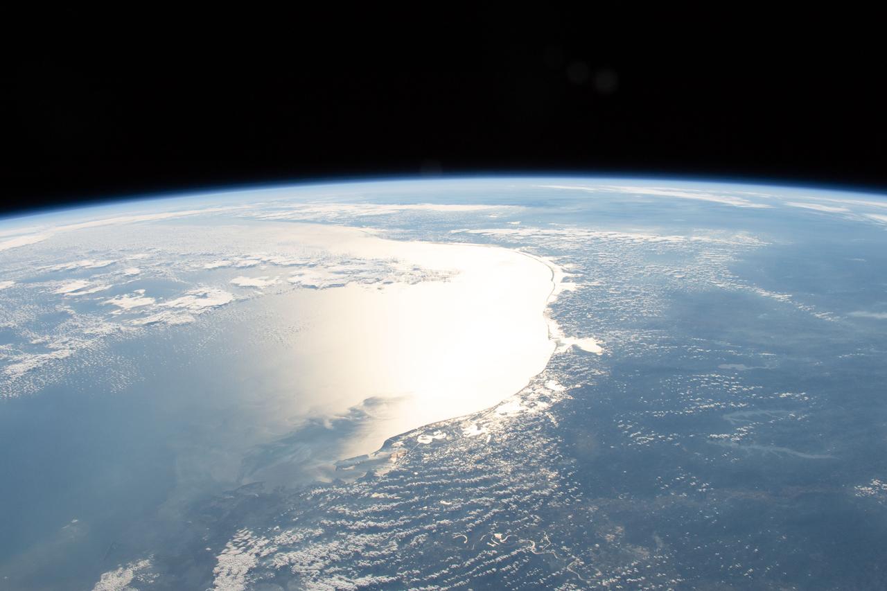iss058e005915 (Jan. 27, 2019) --- The Sun's glint reflects off the Gulf of Mexico and outlines the coasts of Texas and Louisiana. The International Space Station was orbiting 254 miles above Louisiana when an Expedition 58 crew member photographed the Gulf coast including Matagorda Bay, Galvestion Bay and Sabine Lake.