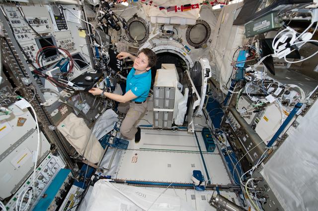 Astronaut Anne McClain works inside the Kibo lab module