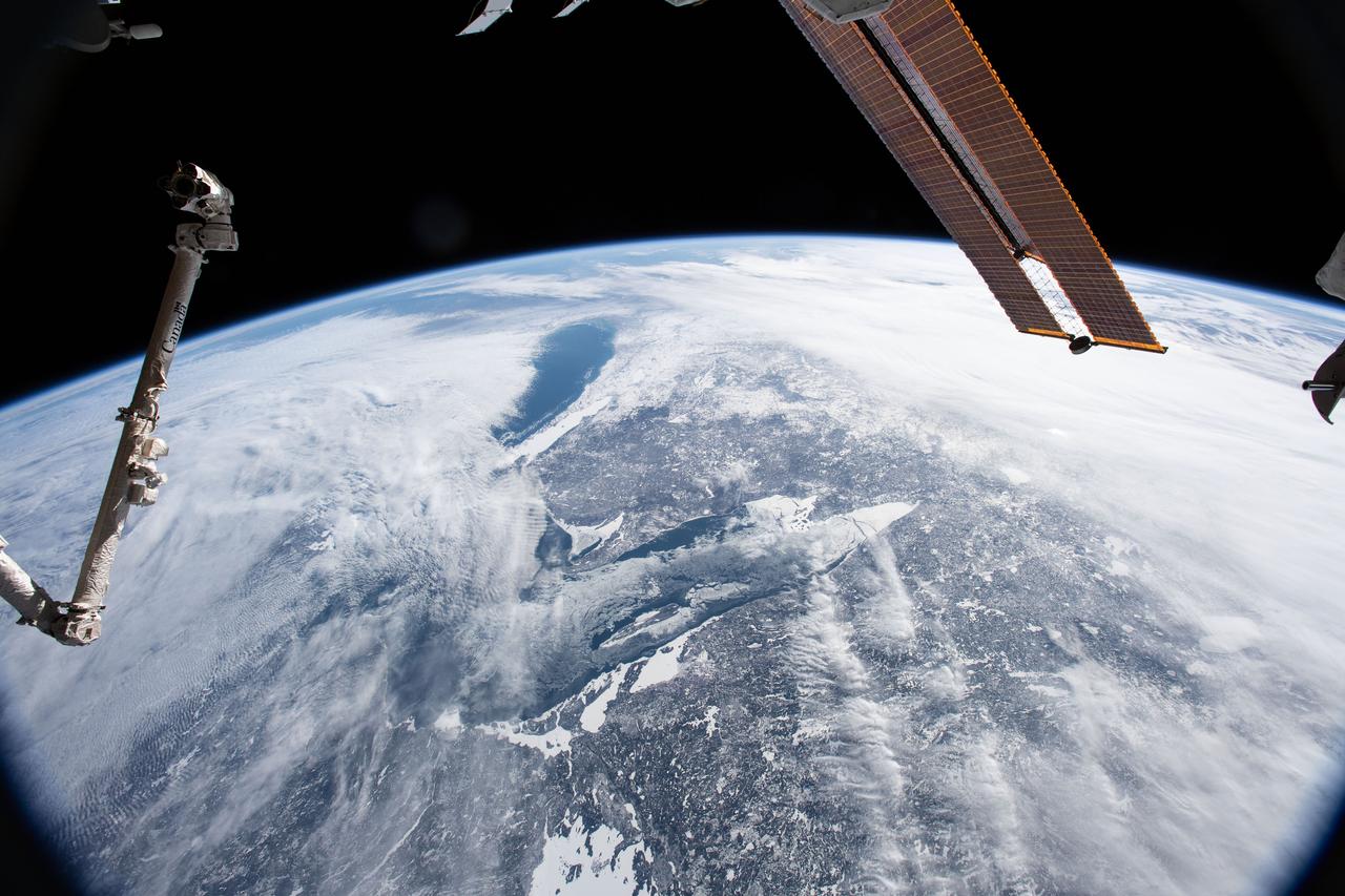 iss058e013234 (Feb. 13, 2019) --- The International Space Station was flying 256 miles above Canada when an Expedition 58 crew member, looking north to south, photographed Lake Superior and Lake Michigan surrounded by the cloudy and frozen terrain of the North American continent.