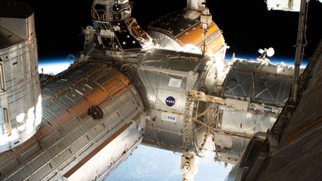 NASA image: The forward end of the International Space Station is pictured showing portions of five modules.