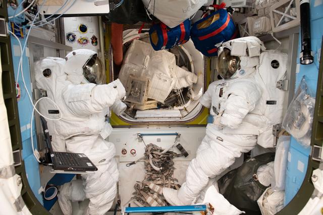 NASA image: A pair of U.S. spacesuits inside the Quest airlock