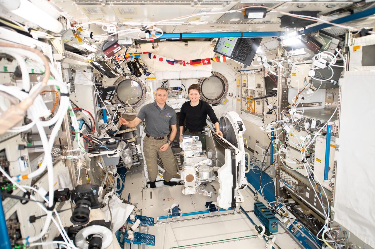 iss058e015664 (2/19/2019) --- NASA astronaut Anne McClain and Canadian Space Agency (CSA) astronaut David Saint-Jacques shown during the installation of the Robotics Refueling Mission (RRM)-3 on the JEM Airlock slide table in the KIBO module aboard the International Space Station (ISS). Robotic Refueling Mission 3 (RRM3) demonstrates the first transfer and long term storage of liquid methane, a cryogenic fluid, in microgravity. The ability to replenish and store cryogenic fluids, which can function as a fuel or coolant, can help enable long duration journeys to destinations like the Moon and Mars.
