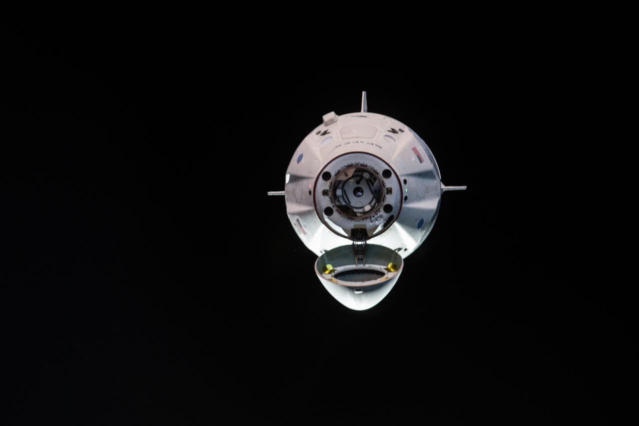 iss058e027064 (March 4, 2019) --- The uncrewed SpaceX Crew Dragon spacecraft is the first Commercial Crew vehicle to visit the International Space Station. Here it is pictured with its nose cone open revealing its docking mechanism while approaching the station's Harmony module. The Crew Dragon would automatically dock moments later to the international docking adapter attached to the forward end of Harmony.