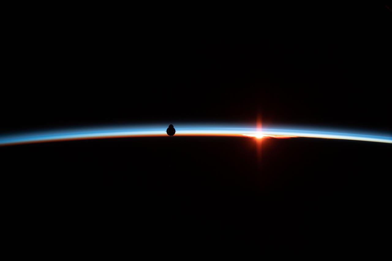 iss058e027197 (March 4, 2019) --- The uncrewed SpaceX Crew Dragon spacecraft is silhouetted against the Earth's horizon during Demo-1, the first flight of NASA's Commercial Crew Program to the International Space Station. The vehicle ultimately docked to the station's Harmony module after completing several successful demonstrations during approach.