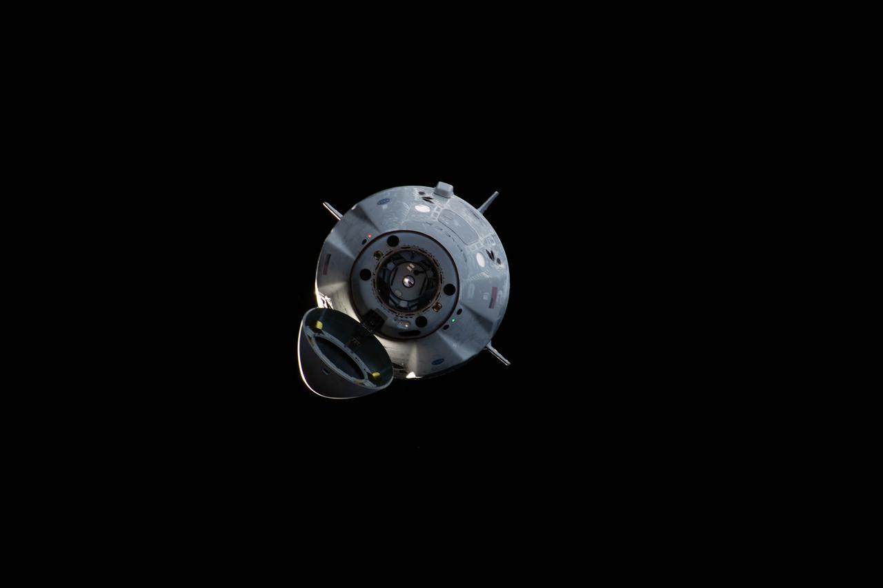 iss058e027295 (March 4, 2019) --- The uncrewed SpaceX Crew Dragon spacecraft is the first Commercial Crew vehicle to visit the International Space Station. Here it is pictured with its nose cone open revealing its docking mechanism while approaching the station's Harmony module. The Crew Dragon would automatically dock moments later to the international docking adapter attached to the forward end of Harmony.