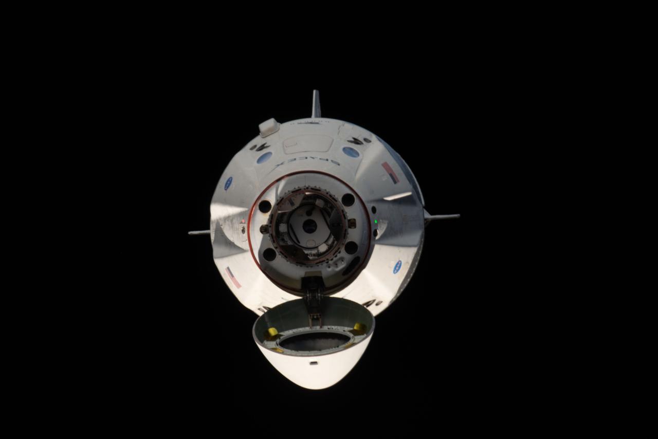 iss058e027548 (March 4, 2019) --- The uncrewed SpaceX Crew Dragon spacecraft is the first Commercial Crew vehicle to visit the International Space Station. Here it is pictured with its nose cone open revealing its docking mechanism while approaching the station's Harmony module. The Crew Dragon would automatically dock moments later to the international docking adapter attached to the forward end of Harmony.