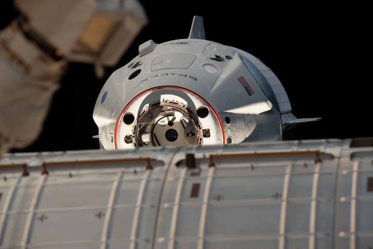 iss058e027550 (March 4, 2019) --- The uncrewed SpaceX Crew Dragon spacecraft is the first Commercial Crew vehicle to visit the International Space Station. Here it is pictured with its nose cone open revealing its docking mechanism while approaching the station's Harmony module. The Crew Dragon would automatically dock moments later to the international docking adapter attached to the forward end of Harmony.