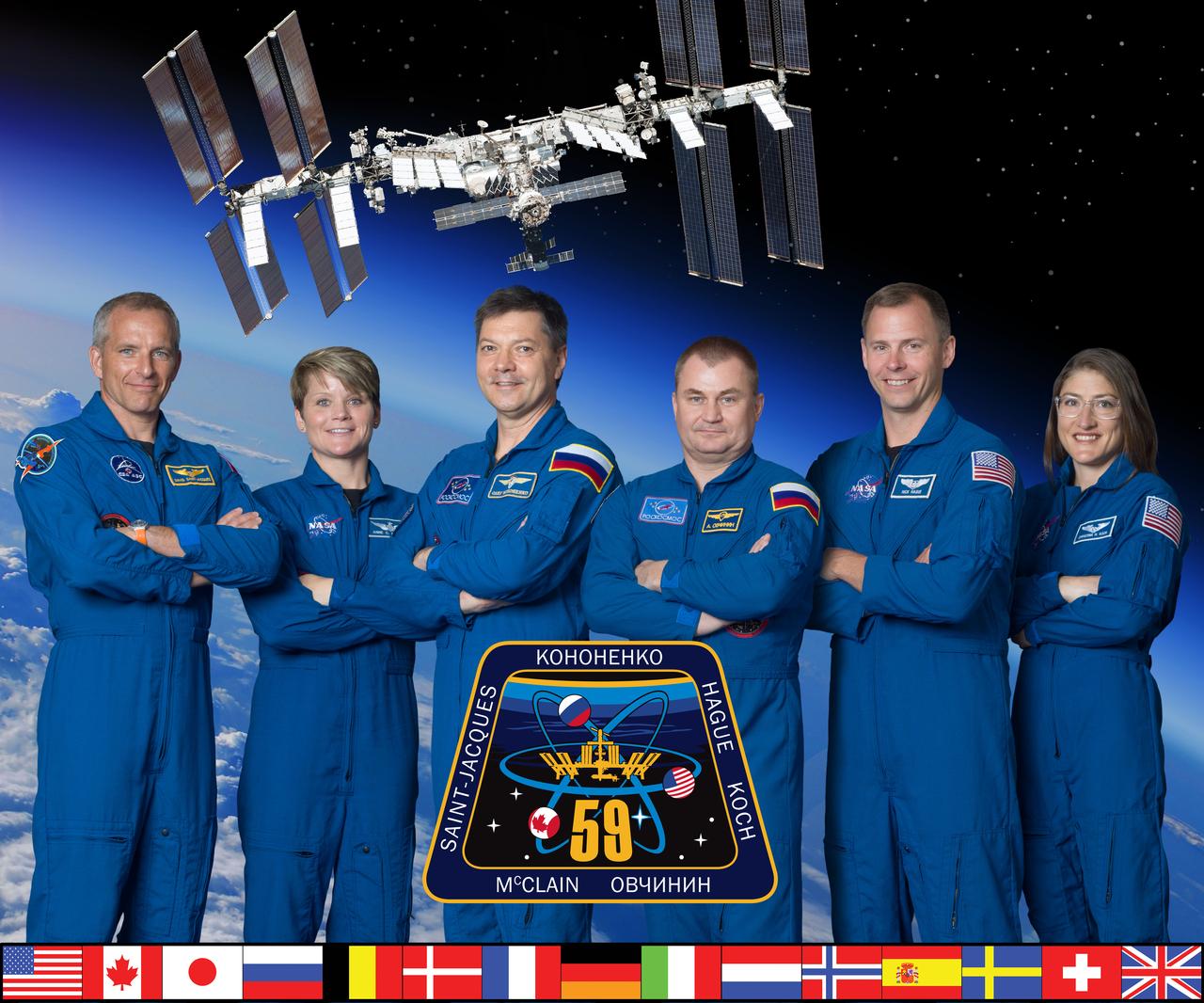 iss059-s-002 (Dec. 13, 2018) --- The official Expedition 59 crew portrait with (from left) astronauts David Saint-Jacques of the Canadian Space Agency and Anne McClain of NASA; cosmonauts Oleg Konenenko and Oleg Shkripochka of Roscosmos; and NASA astronauts Nick Hague and Christina Koch. Credit: NASA/Robert Markowitz