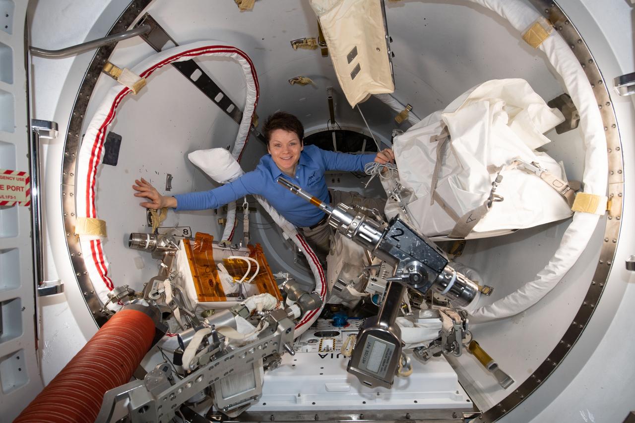 iss059e001041 (March 18, 2019) --- NASA astronaut Anne McClain works inside the crew airlock portion of the U.S. Quest airlock before the Expedition 59 crew members would begin a series of spacewalks to upgrade power systems on the International Space Station. Quest is divided into two parts. The equipment lock is where spacewalkers configure their tools and suit up in their U.S. spacesuits. The crew lock is the unit that is depressurized and repressurized and contains the hatch where the spacewalkers exit into the vacuum of space.