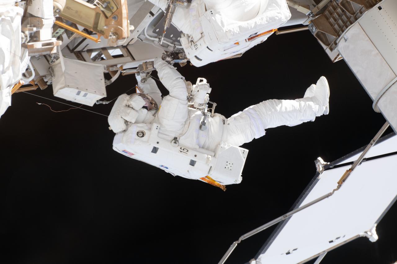 iss059e002192 (March 22, 2019) --- NASA astronaut Nick Hague, in his white U.S. spacesuit with no stripes, is contrasted by the blackness of space during a six-hour, 39-minute spacewalk to upgrade the International Space Station's power storage capacity. This was Hague's and NASA astronaut Anne McClain's (out of frame) first spacewalk.