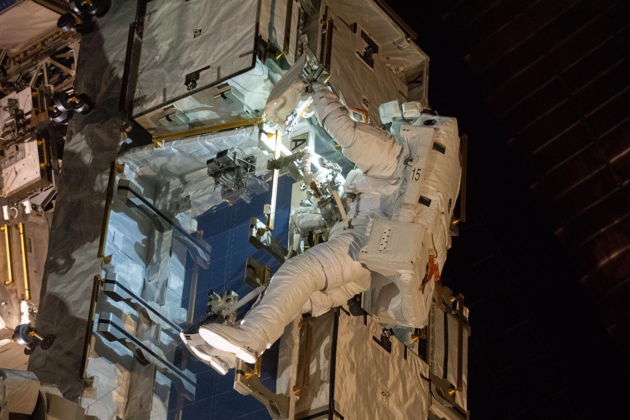 iss059e002268 (March 22, 2019) --- NASA astronaut Nick Hague works to retrieve batteries and adapter plates from an external pallet during a spacewalk to upgrade the International Space Station's power storage capacity.. This was Hague's and NASA astronaut Anne McClain's (out of frame) first spacewalk.