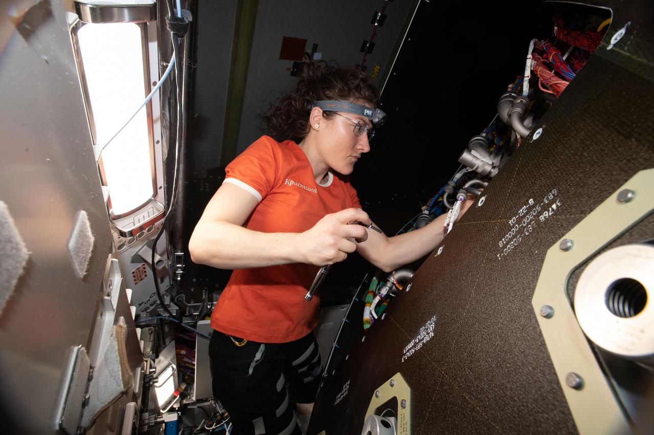 iss059e009964 (April 4, 2018) --- NASA astronaut and Expedition 59 Flight Engineer Christina Koch removes audio hardware from an avionics rack inside the Tranquility module.