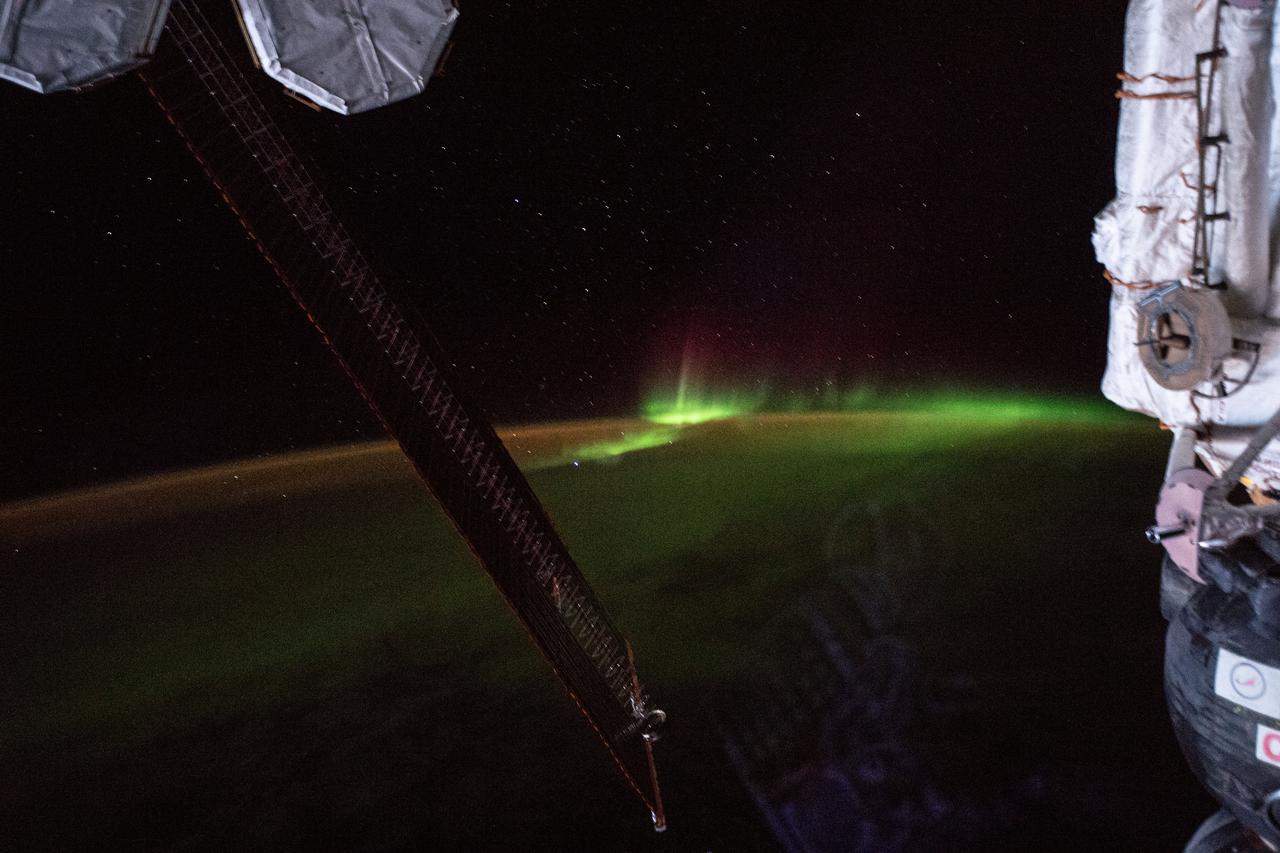 iss059e010180 (April 3, 2019) --- The aurora australis, also known as the "southern lights", is pictured as the International Space Station orbited 265 miles above the Indian Ocean southwest of Australia. Portions of the orbital complex can be seen including (from left) a pair of high-pressure gas tanks, solar arrays and the Soyuz MS-12 crew ship docked to the Rassvet module.
