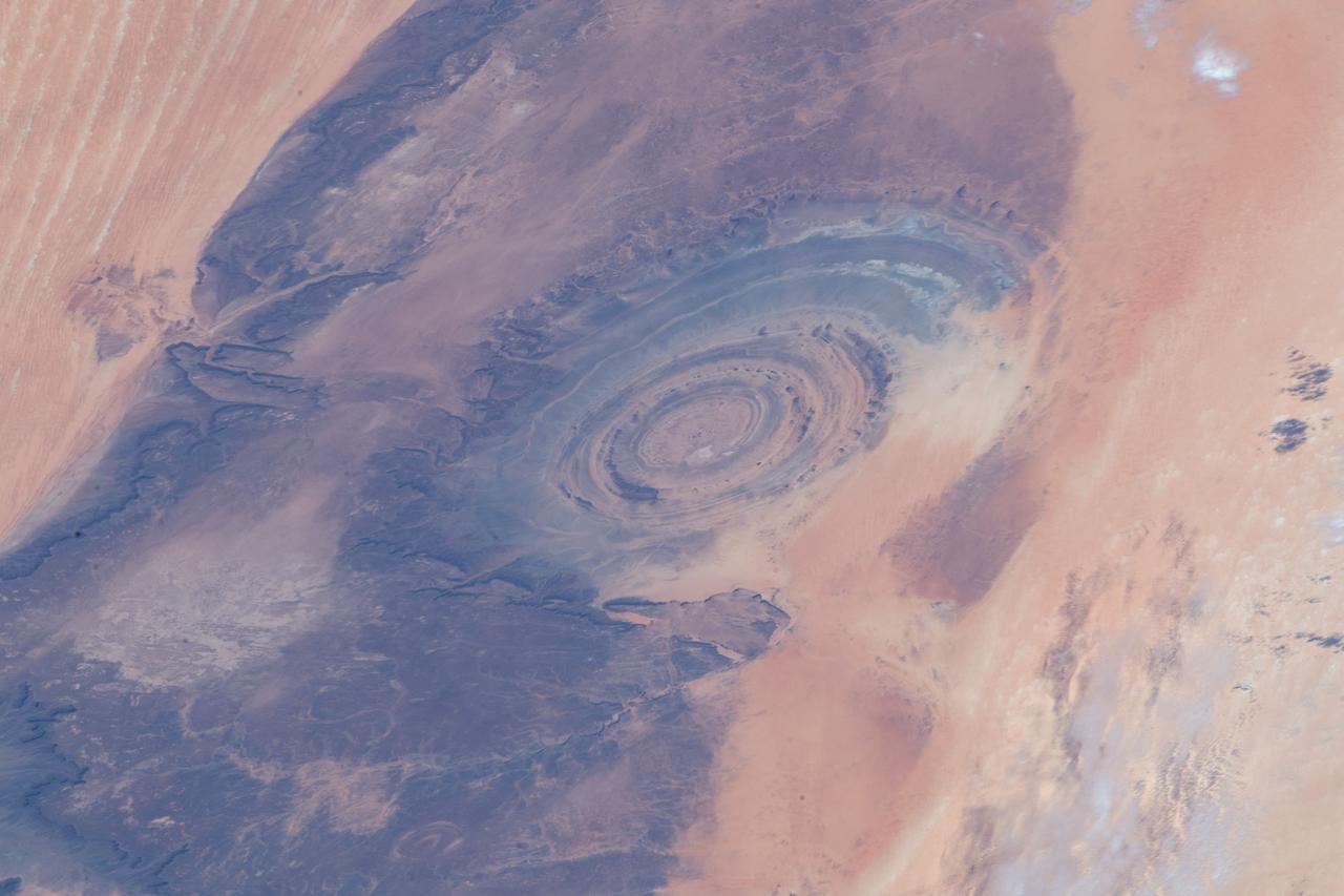 iss059e013142 (April 5, 2019) --- From an altitude of 255 miles, an Expedition 59 crewmember photographed the Richat Structure, or the "Eye of the Sahara," in northwestern Mauritania. The circular geologic feature is thought to be caused by an uplifted dome—geologists would classify it as a domed anticline—that has been eroded to expose the originally flat rock layers.