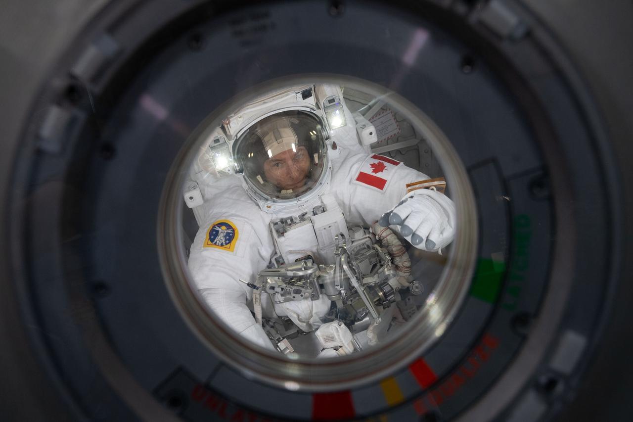 iss059e013306 (April 8, 2019) --- Expedition 59 Flight Engineer David Saint-Jacques of the Canadian Space Agency is seen inside the Quest airlock at the beginning of his first spacewalk. In a six and a half hour spacewalk, Saint-Jacques and NASA astronaut Anne McClain successfully established a redundant path of power to the Canadian-built robotic arm, known as Canadarm2, and installed cables to provide for more expansive wireless communications coverage outside the orbital complex, as well as for enhanced hardwired computer network capability. The duo also relocated an adapter plate from the first spacewalk in preparation for future battery upgrade operations.