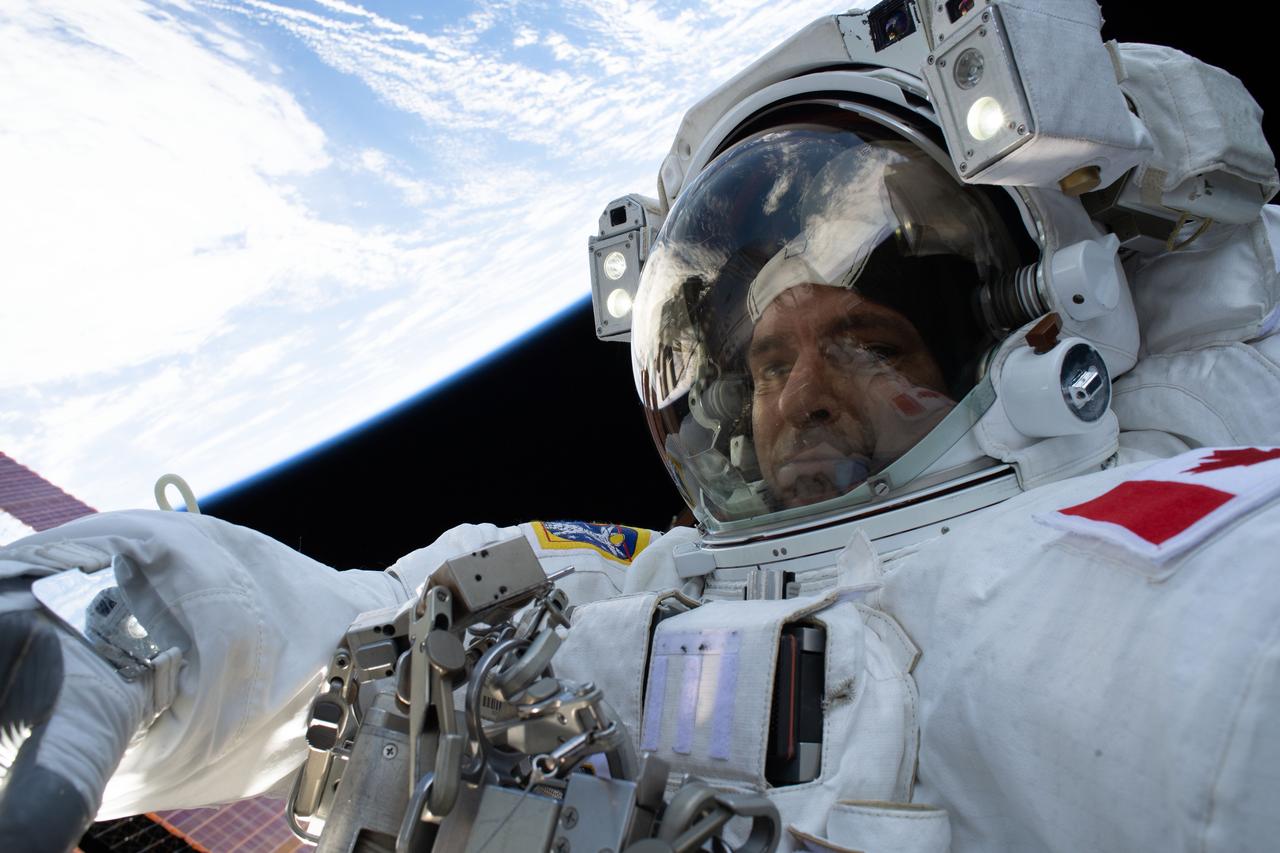 iss059e016628 (April 8, 2019) --- Expedition 59 Flight Engineer David Saint-Jacques of the Canadian Space Agency participates in a six-and-a-half hour spacewalk with NASA astronaut Anne McClain (out of frame). The spacewalkers successfully established a redundant path of power to the Canadian-built robotic arm, known as Canadarm2, and installed cables to provide for more expansive wireless communications coverage outside the orbital complex, as well as for enhanced hardwired computer network capability. The duo also relocated an adapter plate from the first spacewalk in preparation for future battery upgrade operations.