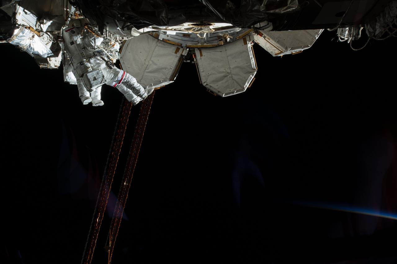 iss059e016966 (April 8, 2019) --- Expedition 59 Flight Engineers Anne McClain of NASA (red stripes) and David Saint-Jacques of the Canadian Space Agency are seen while working outside the International Space Station. In a six and a half hour spacewalk, McClain and Saint-Jacques successfully established a redundant path of power to the Canadian-built robotic arm, known as Canadarm2, and installed cables to provide for more expansive wireless communications coverage outside the orbital complex, as well as for enhanced hardwired computer network capability. The duo also relocated an adapter plate from the first spacewalk in preparation for future battery upgrade operations.