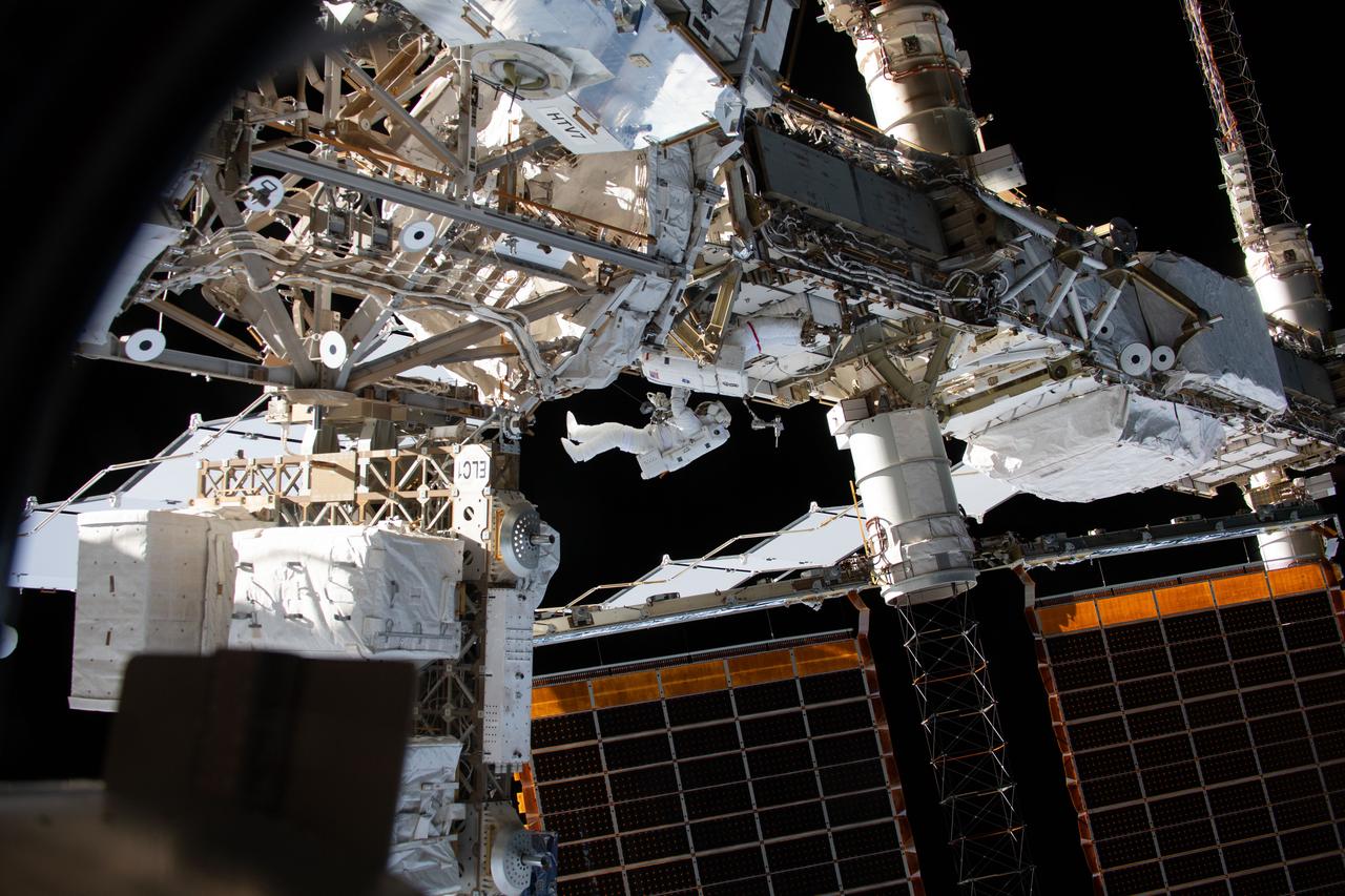iss059e016991 (April 8, 2019) --- Expedition 59 Flight Engineers Anne McClain of NASA (red stripes) and David Saint-Jacques of the Canadian Space Agency are seen while working outside the International Space Station. In a six and a half hour spacewalk, McClain and Saint-Jacques successfully established a redundant path of power to the Canadian-built robotic arm, known as Canadarm2, and installed cables to provide for more expansive wireless communications coverage outside the orbital complex, as well as for enhanced hardwired computer network capability. The duo also relocated an adapter plate from the first spacewalk in preparation for future battery upgrade operations.