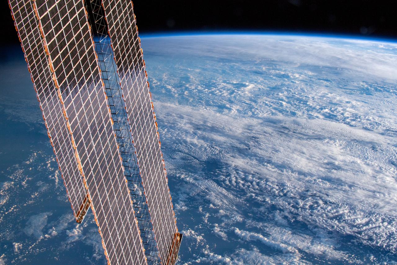 iss059e019924 (April 11, 2019) --- 261 miles above Earth and off the coast of the Australian cities of Gold Coast and Brisbane, an Expedition 59 crew member photographed the cloud-covered Tasman and Coral Seas. A portion of the International Space Station's solar arrays drape over the Earth as the orbital lab passes over the terminator, the line that separates night from day.