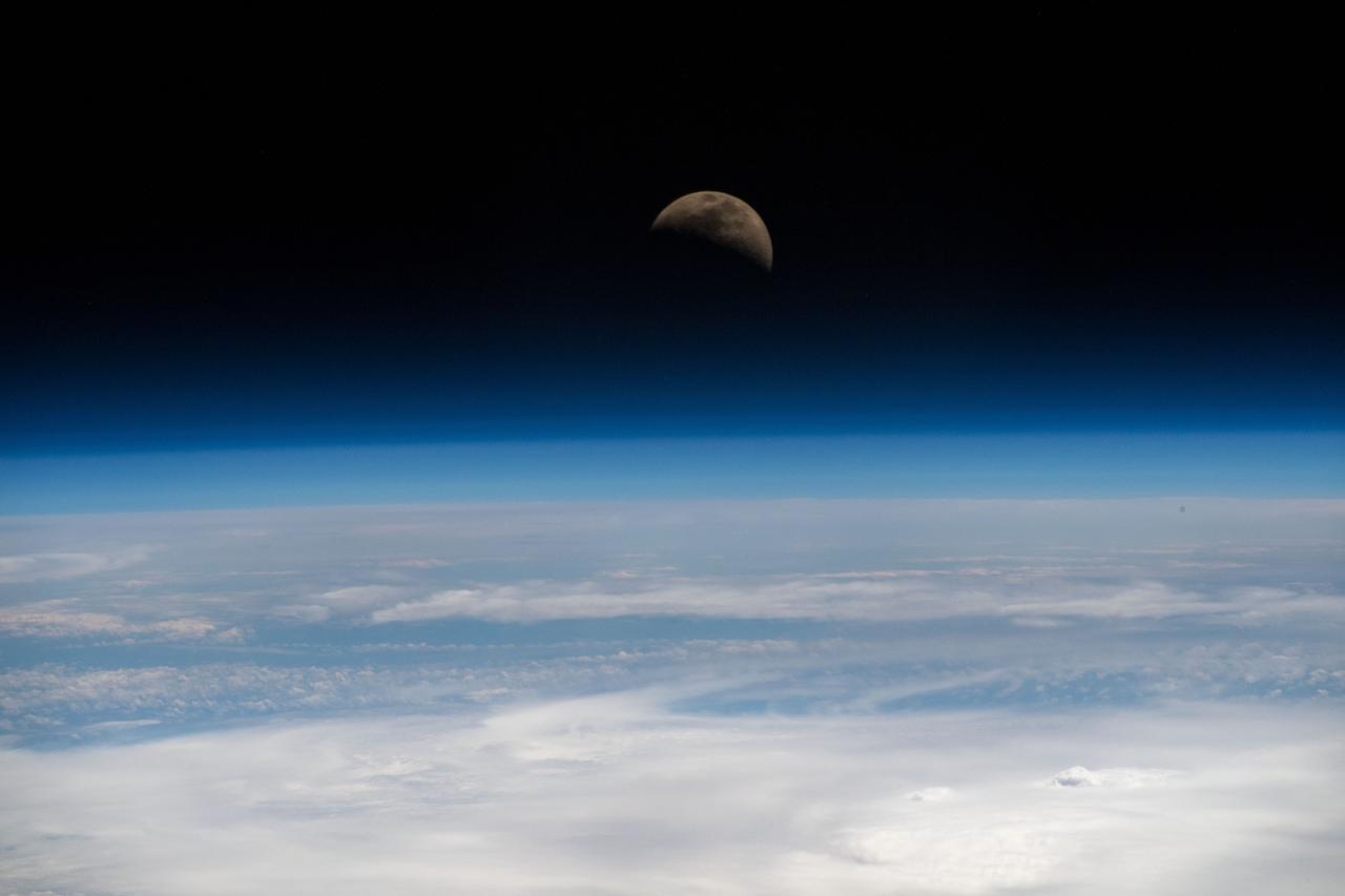 iss059e019955 (April 11, 2019) --- The moon is photographed in its first quarter phase just above the Earth's limb as the International Space Station orbited 255 miles above the Pacific Ocean south of the Hawaiian island chain.