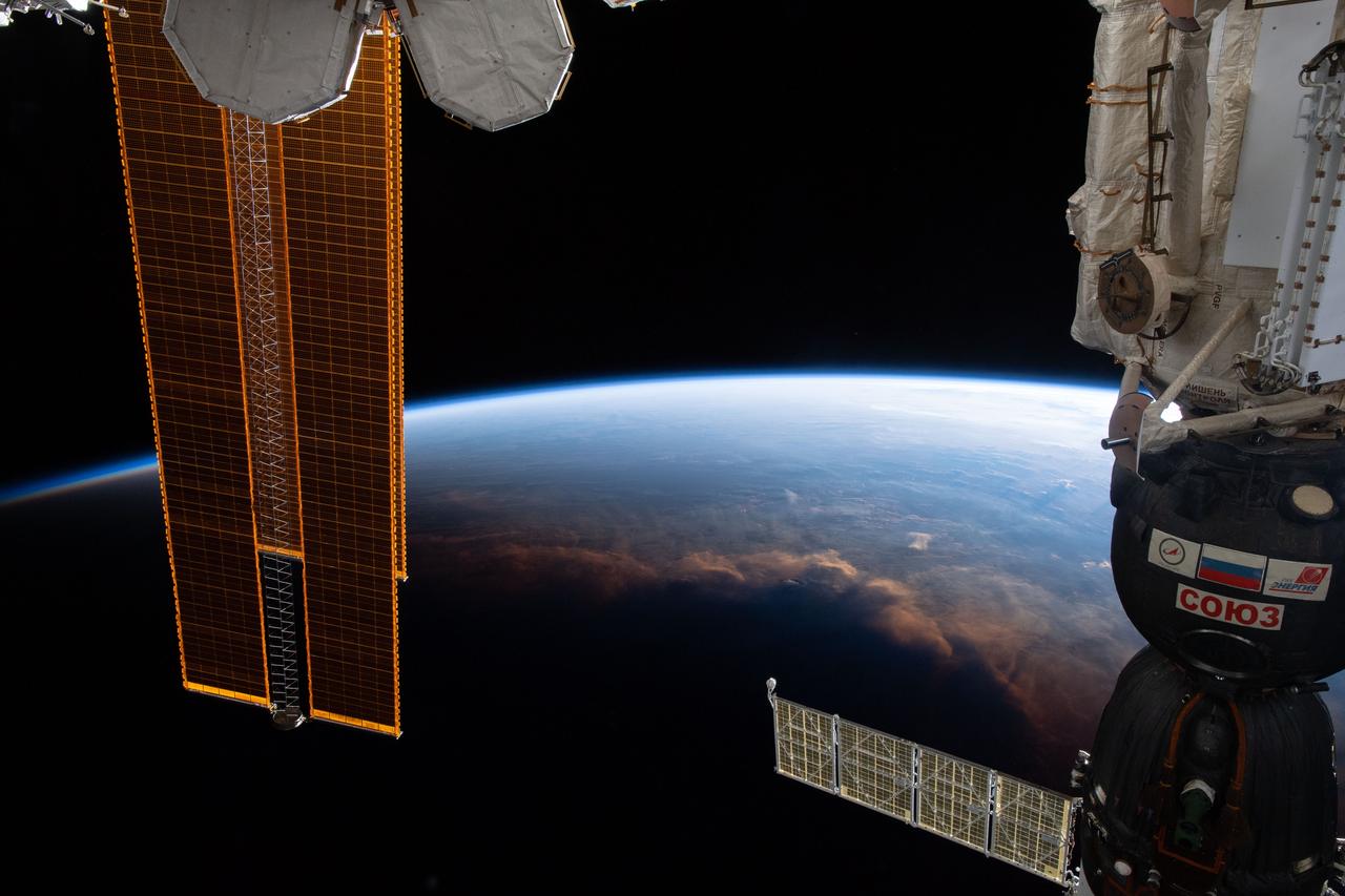 iss059e025207 (April 17, 2019) --- The International Space Station crosses the terminator, the line that separates night and day on Earth, as it orbits 254 miles above the Gulf of Guinea on Africa's mid-western coast. Portions of the orbital complex can be seen including a pair of high-pressure gas tanks, solar arrays and the Soyuz MS-12 crew ship docked to the Rassvet module.