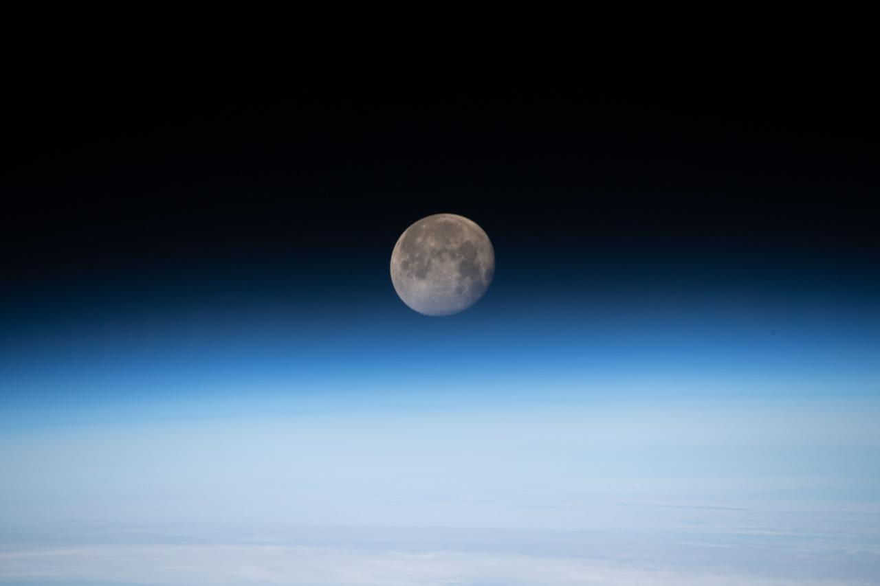 iss059e027725 (April 21, 2019) --- The moon is photographed in its waning gibbous phase just above the Earth's limb as the International Space Station orbited 258 miles above the North Atlantic Ocean just off the Canadian-American coast.