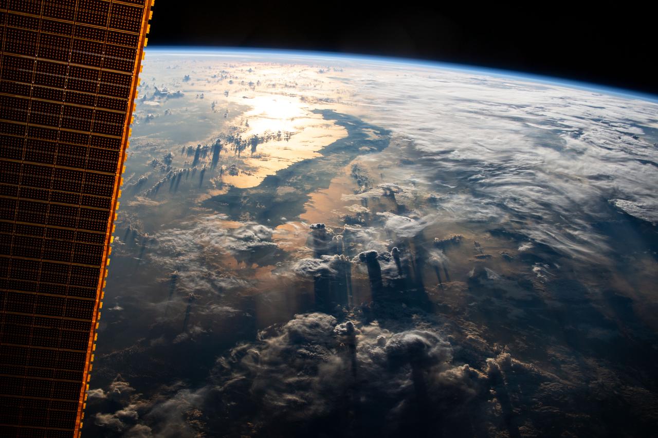 iss059e067877 (May 19, 2019) --- The International Space Station flies 255 miles above Indonesia as the sun's glint beams off the Celebes Sea in southeast Asia.