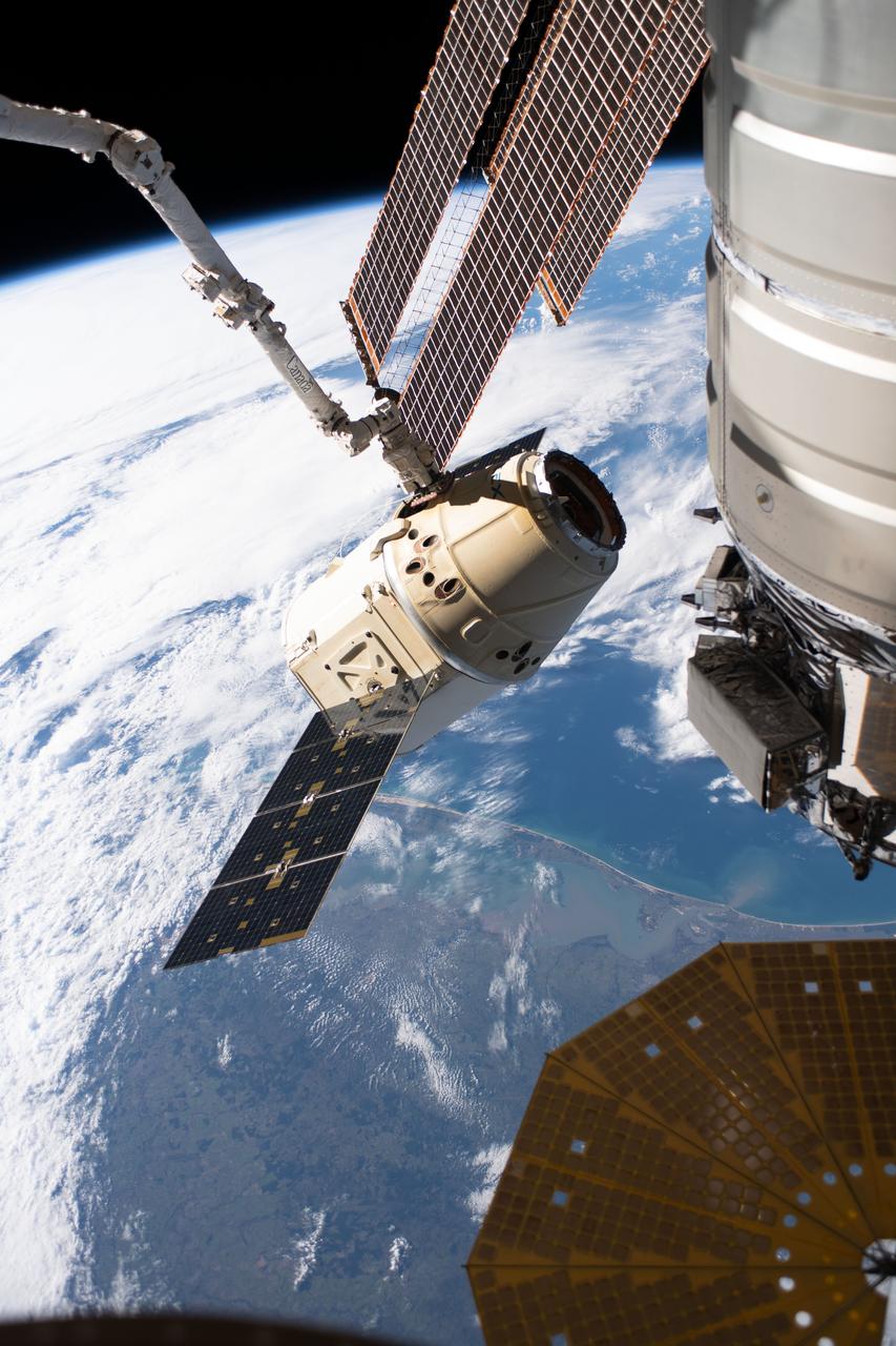iss059e088996 (June 3, 2019) --- The SpaceX Dragon cargo craft on its 17th contracted mission to resupply mission to the International Space Station is pictured moments before being released from the Canadarm2 robotic arm. The orbiting lab was flying 261 miles above the Atlantic coast of South America.