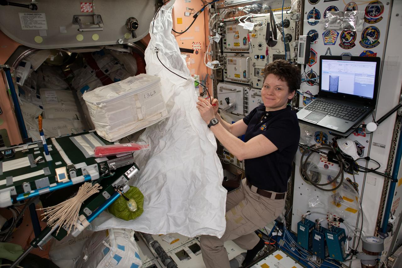 iss059e092264 (June 5, 2019) --- NASA astronaut Anne McClain assembles a hygiene cover that will cover a rack bay inside the Permanent Multipurpose Module.