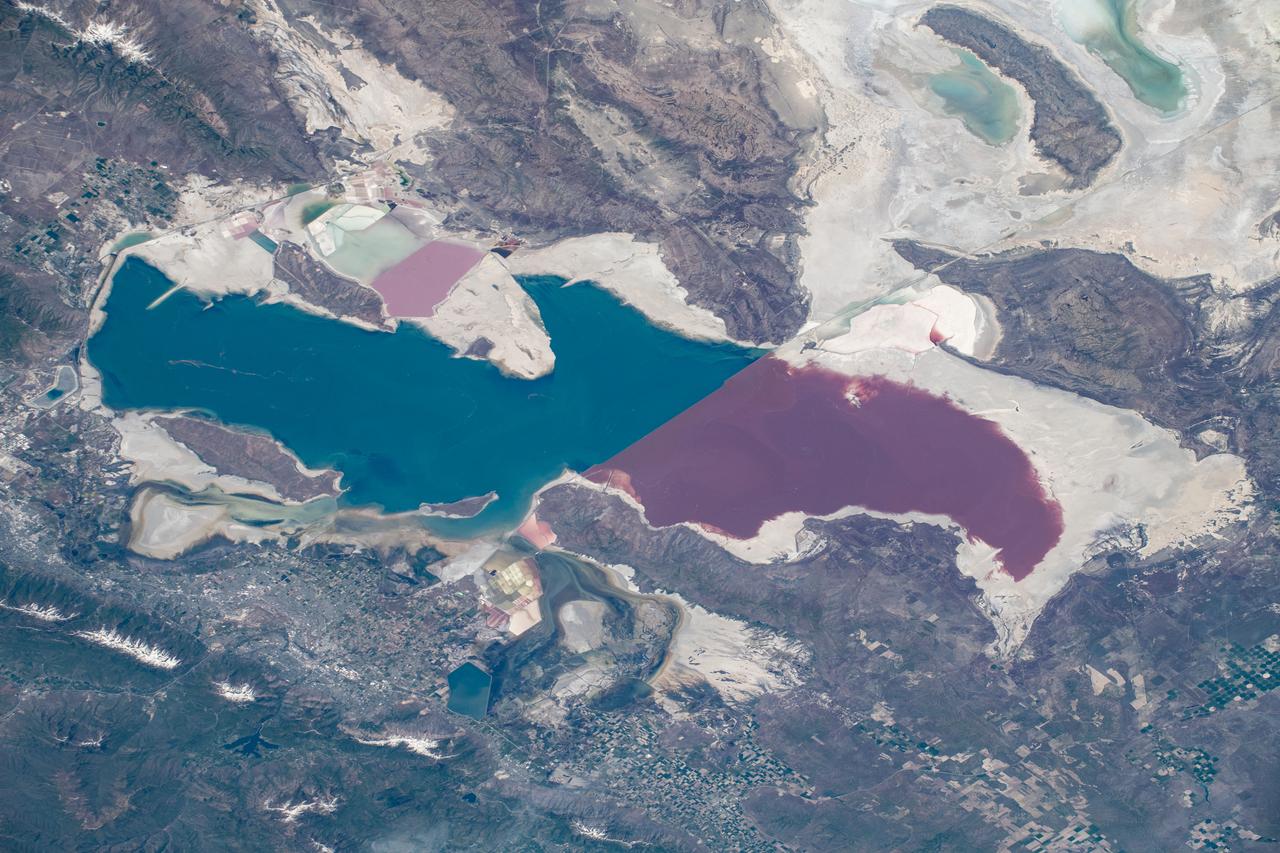 iss059e099093 (June 10, 2019) --- Utah's Great Salt Lake is pictured as the International Space Station orbited 255 miles above the southwestern United States. The distinct color differences in the lake is caused by a railroad causeway. The northern part of the lake (pointing right in this frame) has a much higher salinity than the southern freshwater portion of the lake.