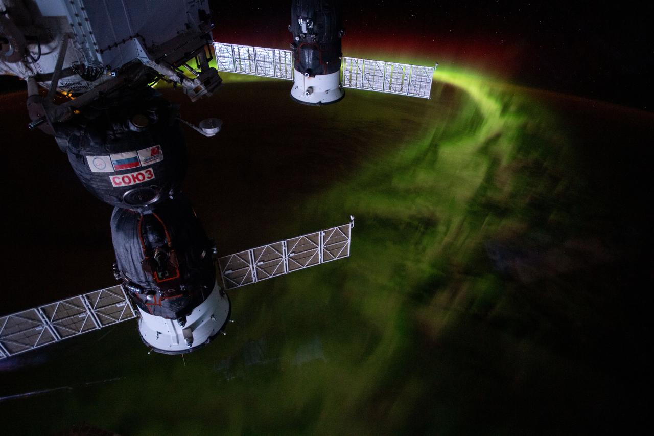 iss059e099150 (June 8, 2019) --- The International Space Station was orbiting 269 miles above the Indian Ocean southwest of Australia when this nighttime photograph was taken of the aurora australis, or "southern lights." Russia's Soyuz MS-12 crew ship (foreground) and Progress 72 resupply ship are seen in this mesmerizing view.