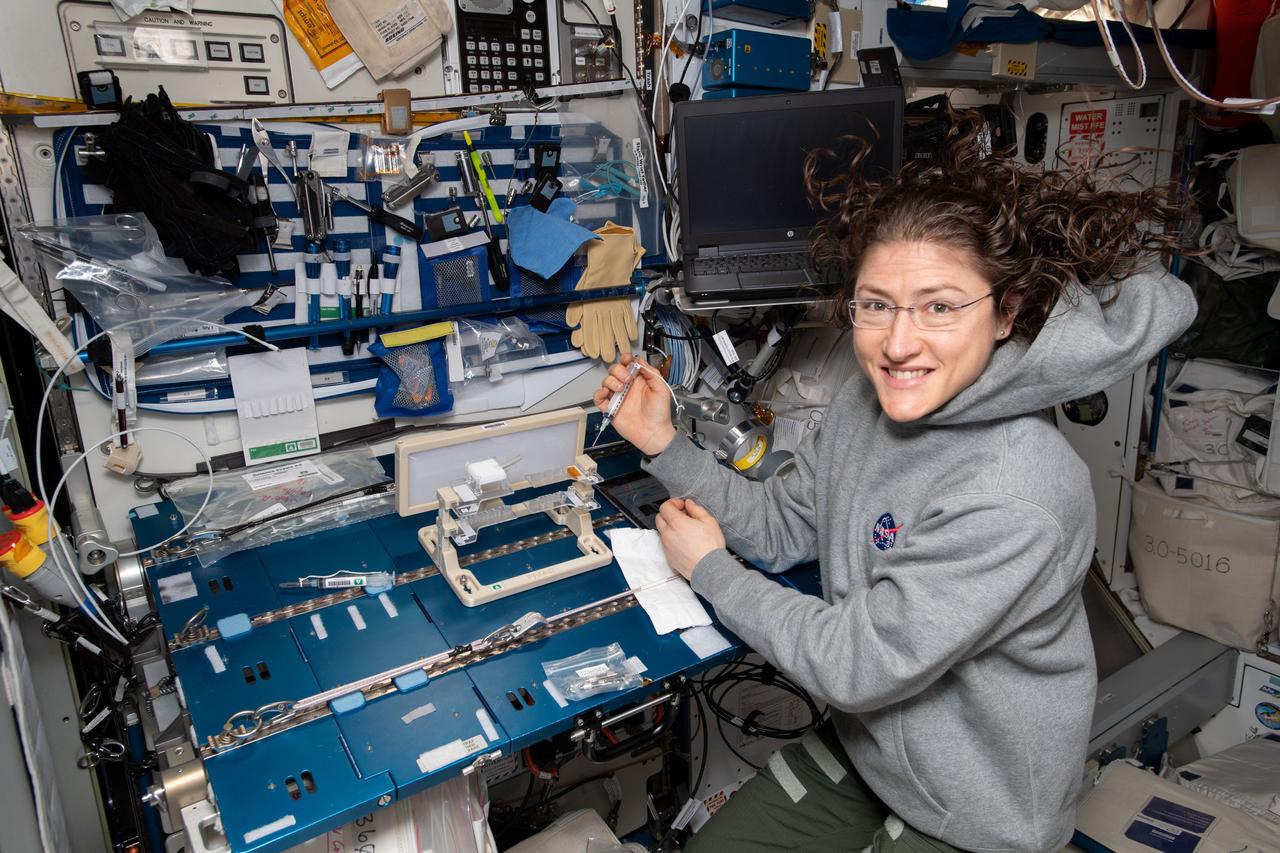iss059e101367 (June 12, 2019) --- NASA astronaut Christina Koch checks out hardware for the Capillary Structures experiment. The investigation studies a new method of using structures of specific shapes to manage fluid and gas mixtures for more reliable life support systems on future space missions.