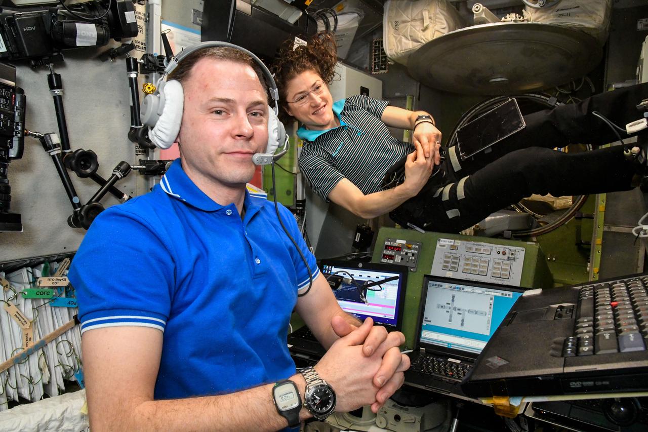 iss059e103111 (June 13, 2019) --- NASA astronauts Nick Hague and Christina Koch practice an emergency simulation inside the International Space Station's Zvezda service module. The duo along with cosmonaut Alexey Ovchinin (out of frame) practiced emergency procedures for quickly entering their Soyuz lifeboat, undocking from the station and descending to Earth. Credit: Roscosmos