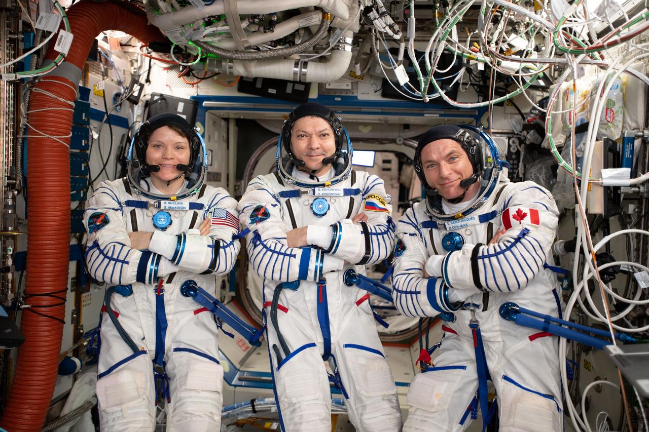 iss059e103489 (June 17, 2019) --- Expedition 59 crew members (from left) Anne McClain, Oleg Kononenko and David Saint-Jacques are wearing the Sokol launch and entry suits they will wear on the way back to Earth aboard the Soyuz MS-11 crew ship.