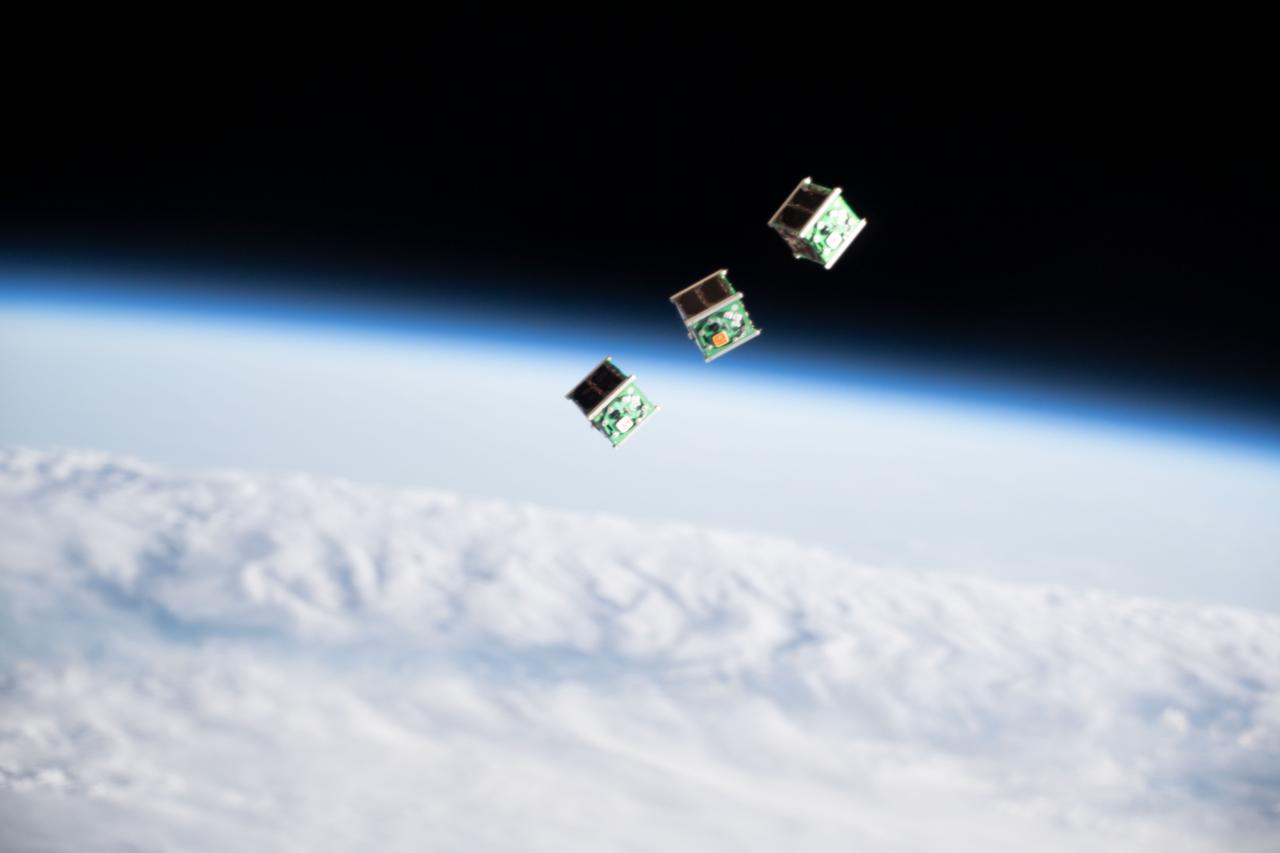 iss059e104766 (June 17, 2019) --- A set of three CubeSats are pictured shortly after being ejected from the Japanese Small Satellite Orbital Deployer attached to a robotic arm outside of the Japan Aerospace Exploration Agency's Kibo laboratory module. The tiny satellites from Nepal, Sri Lanka and Japan were released into Earth orbit for technology demonstrations.