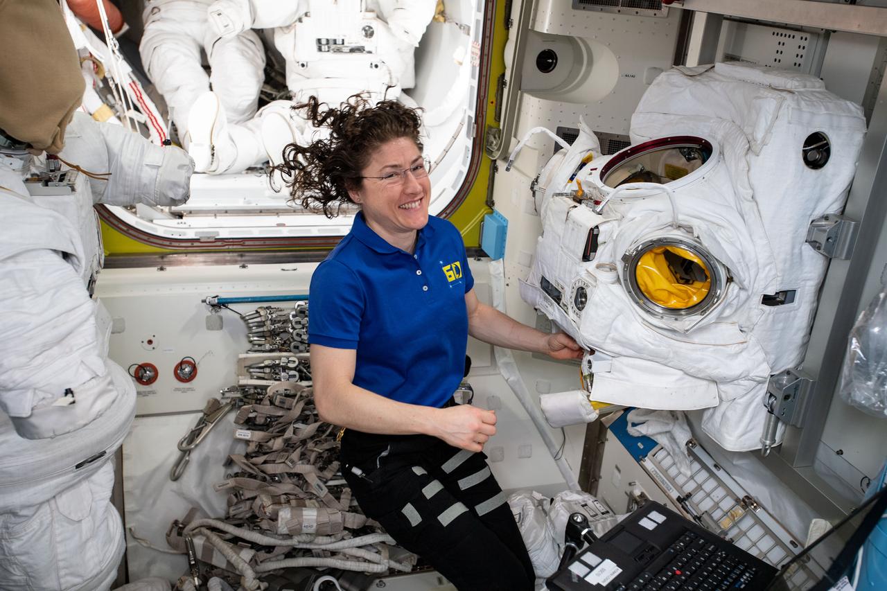 iss060e000808 (June 26, 2019) --- Expedition 60 Flight Engineer Christina Koch of NASA works on a U.S. spacesuit in the Quest airlock where U.S. spacewalks are staged aboard the International Space Station.