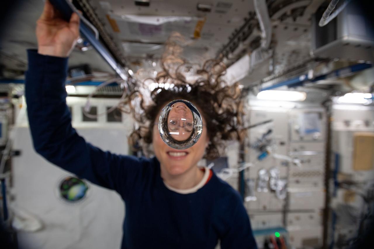 iss060e001486 (July 29, 2019) --- Expedition 60 Flight Engineer Christina Koch of NASA playfully demonstrates how fluids behave in the weightless environment of microgravity aboard the International Space Station.