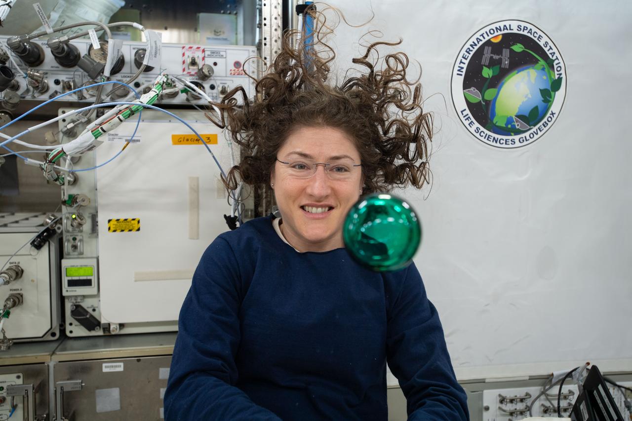 iss060e001489 (July 29, 2019) --- Expedition 60 Flight Engineer Christina Koch of NASA playfully demonstrates how fluids behave in the weightless environment of microgravity aboard the International Space Station.